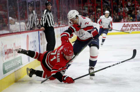 RALEIGH, NC – MARCH 28: Lucas Wallmark #71 of the Carolina Hurricanes battles along the boards with Matt Niskanen #2 of the Washington Capitals during an NHL game on March 28, 2019 at PNC Arena in Raleigh, North Carolina. (Photo by Gregg Forwerck/NHLI via Getty Images)