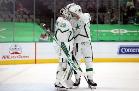 DALLAS, TEXAS – APRIL 20: Jake Oettinger #29 and Jamie Oleksiak #2 of the Dallas Stars celebrate a 5-2 win against the Detroit Red Wings in the third period at American Airlines Center on April 20, 2021 in Dallas, Texas. (Photo by Ronald Martinez/Getty Images)