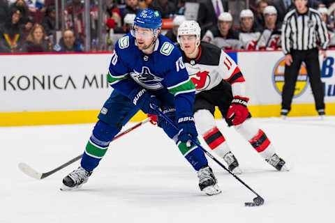 Mar 15, 2022; Vancouver, British Columbia, CAN; New Jersey Devils forward Andreas Johnsson (11) looks on as Vancouver Canucks forward Tanner Pearson (70) shoots in the third period at Rogers Arena. Vancouver won 6-3. Mandatory Credit: Bob Frid-USA TODAY Sports