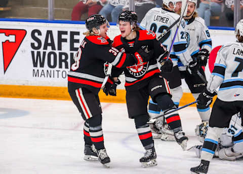 WINNIPEG, CANADA – JANUARY 21: Atley Calvert #23 and Ryder Korczak #38 of the Moose Jaw Warriors celebrate a third-period goal against the Winnipeg ICE at Wayne Fleming Arena on January 21, 2023, in Winnipeg, Manitoba, Canada. (Photo by Jonathan Kozub/Getty Images)