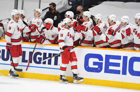 Mar 2, 2021; Nashville, Tennessee, USA; Carolina Hurricanes center Vincent Trocheck (16) is congratulated by teammates after a goal during the first period against the Nashville Predators at Bridgestone Arena. Mandatory Credit: Christopher Hanewinckel-USA TODAY Sports