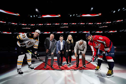 WASHINGTON, DC – DECEMBER 11: (L-R) Zdeno Chara #33 of the Boston Bruins, former NHL player Tim Thomas, former NHL player Brian Gionta, Olympian Krissy Wendell, Fort Dupont Ice Arena Founder Neal Henderson, and Alex Ovechkin #8 of the Washington Capitals take part in a ceremonial puck drop honoring the 2019 U.S. Hockey Hall of Fame Class at Capital One Arena on December 11, 2019 in Washington, DC. (Photo by Patrick McDermott/NHLI via Getty Images)