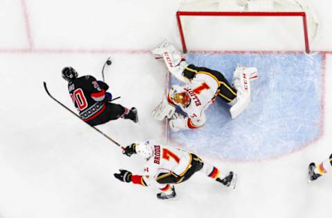 Feb 26, 2017; Raleigh, NC, USA; Calgary Flames goalie Brian Elliott (1) stops the shot by Carolina Hurricanes forward Sebastian Aho (20) at PNC Arena. The Calgary Flames defeated the Carolina Hurricanes 3-1. Mandatory Credit: James Guillory-USA TODAY Sports