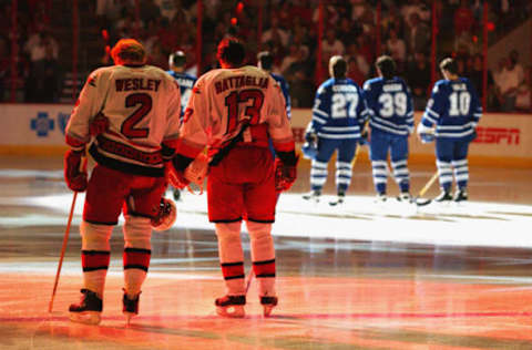 RALEIGH, NC – MAY 25: Defenseman Glen Wesley #2 and left wing Bates Battaglia #13 of the Carolina Hurricanes stand on the ice for the national anthems before game five of the Eastern Conference finals in the Stanley Cup playoffs against the Toronto Maple Leafs at the Raleigh Sports Arena in Raleigh, North Carolina on May 25, 2002. The Maple Leafs won 1-0. (Photo by Doug Pensinger/Getty Images/NHLI)