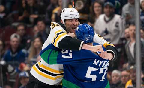 Zdeno Chara and Tyler Myers drop the gloves as Bruins and Canucks clash. (Photo by Rich Lam/Getty Images)