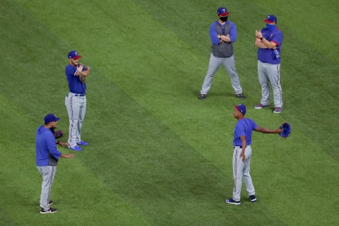 Texas Rangers pitching staff and coaches warm up (Photo by Tom Pennington/Getty Images)