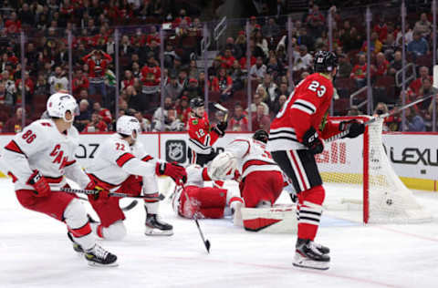 CHICAGO, ILLINOIS – NOVEMBER 03: Alex DeBrincat #12 of the Chicago Blackhawks scores a goal during the second period against the Carolina Hurricanes at United Center on November 03, 2021, in Chicago, Illinois. (Photo by Stacy Revere/Getty Images)