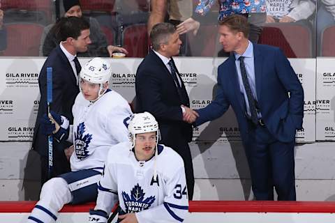 GLENDALE, ARIZONA - NOVEMBER 21: Head coach Sheldon Keefe (C) of the Toronto Maple Leafs shakes hands with assistant coach Dave Hakstol after defeating the Arizona Coyotes in the NHL game at Gila River Arena on November 21, 2019 in Glendale, Arizona. The Maple Leafs defeated the Coyotes 3-1. (Photo by Christian Petersen/Getty Images)