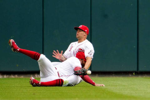 Cincinnati Reds left fielder Tommy Pham (28) and Cincinnati Reds center fielder Nick Senzel (15) collide chasing a fly ball in the third inning during a baseball game, Tuesday, April 12, 2022, at Great American Ball Park in Cincinnati, Ohio.Cleveland Guardians At Cincinnati Reds Home Opener April 12 0368