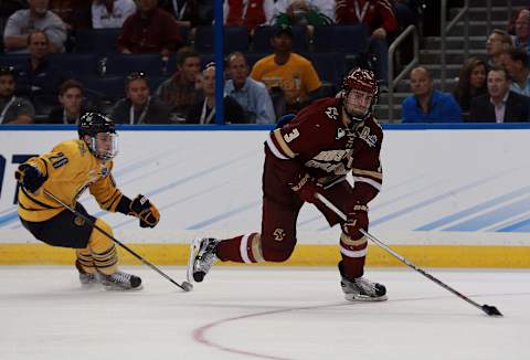 Apr 7, 2016; Tampa, FL, USA; Boston College Eagles defenseman Ian McCoshen (3) skates with the puck as Boston College Eagles forward Austin Cangelosi (26) defends during the third period of the semifinals of the 2016 Frozen Four college ice hockey tournament at Amalie Arena. Quinnipiac Bobcats defeated the Boston College Eagles 3-2. Mandatory Credit: Kim Klement-USA TODAY Sports