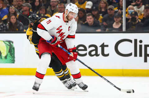 BOSTON, MA – MAY 08: Jordan Staal #11 of the Carolina Hurricanes and David Pastrnak #88 of the Boston Bruins fight for the puck in the sen period in Game Four of the First Round of the 2022 Stanley Cup Playoffs at TD Garden on May 8, 2022, in Boston, Massachusetts. (Photo by Adam Glanzman/Getty Images)