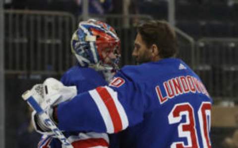 Igor Shesterkin #31 of the New York Rangers (L) who was playing in his first NHL game records a 5-3 victory over the Colorado Avalanche and is embraced by Henrik Lundqvist #30