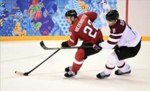 Swiss forward Nino Niederreiter (#22) forces his way around a Latvian defender in Switzerland’s 1-0 shutout win.