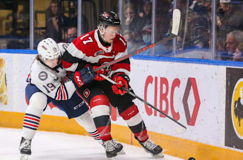 OSHAWA, ONTARIO - NOVEMBER 14: Luca Marrelli #19 of the Oshawa Generals battles for the puck with Brady Stonehouse #17 of the Ottawa 67s during the second period at Tribute Communities Centre on November 14, 2021 in Oshawa, Ontario. (Photo by Chris Tanouye/Getty Images)