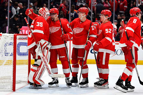 Feb 21, 2023; Washington, District of Columbia, USA; Detroit Red Wings right wing Jonatan Berggren (52) celebrates with goaltender Ville Husso (35) after the game against the Washington Capitals at Capital One Arena. Mandatory Credit: Brad Mills-USA TODAY Sports