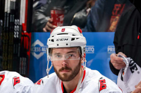 WINNIPEG, MB – DECEMBER 17: Joel Edmundson #6 of the Carolina Hurricanes looks on from the bench prior to puck drop against the Winnipeg Jets at the Bell MTS Place on December 17, 2019 in Winnipeg, Manitoba, Canada. (Photo by Jonathan Kozub/NHLI via Getty Images)