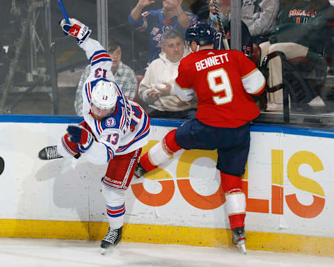 SUNRISE, FL – DECEMBER 29: Alexis Lafreniere #13 of the New York Rangers and Sam Bennett #9 of the Florida Panther come together along the boards during-second period action at the FLA Live Arena on December 29, 2021 in Sunrise, Florida. (Photo by Joel Auerbach/Getty Images)