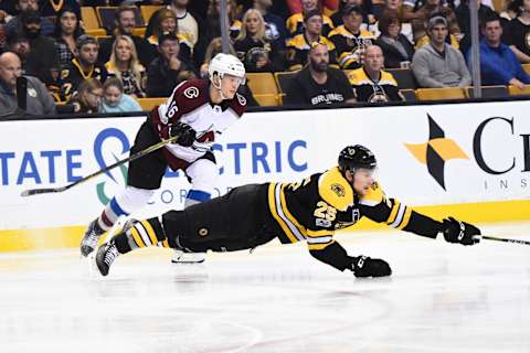 BOSTON, MA – OCTOBER 9: Brandon Carlo #25 of the Boston Bruins reaches out for the puck against Nikita Zadorov #16 of the Colorado Avalanche at the TD Garden on October 9, 2017 in Boston, Massachusetts. (Photo by Brian Babineau/NHLI via Getty Images)