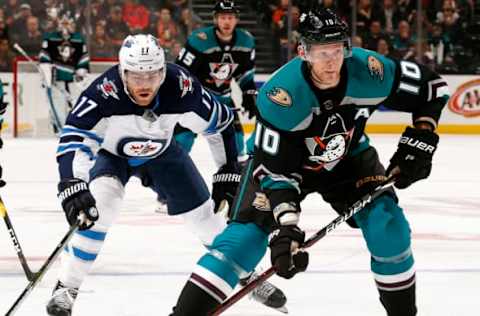 ANAHEIM, CA – MARCH 20: Corey Perry #10 of the Anaheim Ducks controls the puck with pressure from Adam Lowry #17 of the Winnipeg Jets during the game on March 20, 2019 at Honda Center in Anaheim, California. (Photo by Debora Robinson/NHLI via Getty Images)