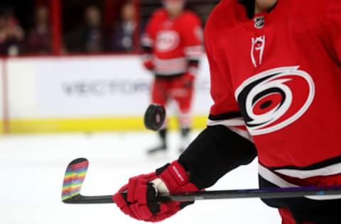 RALEIGH, NC – MARCH 24: Teammates of the Carolina Hurricanes use pride tape to commemorate Hockey is for Everyone during warm ups prior to an NHL game against the Montreal Canadiens on March 24, 2019 at PNC Arena in Raleigh, North Carolina. (Photo by Gregg Forwerck/NHLI via Getty Images)