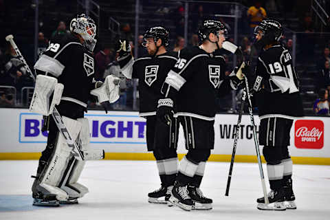 Mar. 16, 2023; Los Angeles, California, USA; Los Angeles Kings goaltender Pheonix Copley (29), right wing Viktor Arvidsson (33), defenseman Sean Walker (26), and left-wing Alex Iafallo (19) celebrate the victory against the Columbus Blue Jackets at Crypto.com Arena. Mandatory Credit: Gary A. Vasquez-USA TODAY Sports