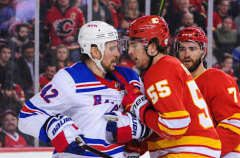 CALGARY, AB – MARCH 15: Noah Hanifin #55 of the Calgary Flames exchanges words after the whistle with Brendan Smith #42 of the New York Rangers during an NHL game at Scotiabank Saddledome on March 15, 2019 in Calgary, Alberta, Canada. (Photo by Derek Leung/Getty Images)