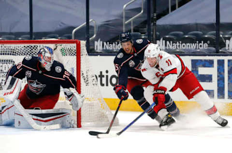 Feb 8, 2021; Columbus, Ohio, USA; Carolina Hurricanes center Jordan Staal (11) moves in for a shot against Columbus Blue Jackets defenseman Michael Del Zotto (15) during the second period at Nationwide Arena. Mandatory Credit: Russell LaBounty-USA TODAY Sports