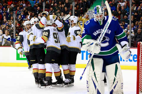 VANCOUVER, BC – MARCH 9: Jacob Markstrom #25 of the Vancouver Canucks looks on dejected as Tomas Nosek #92 of the Vegas Golden Knights is congratulated by teammates after scoring during their NHL game at Rogers Arena March 9, 2019 in Vancouver, British Columbia, Canada. Vegas won 6-2. (Photo by Jeff Vinnick/NHLI via Getty Images)