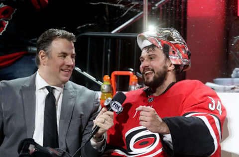 RALEIGH, NC – APRIL 4: Game night host Mike Maniscalco of the Carolina Hurricanes interviews Petr Mrazek #34 during an NHL game against the New Jersey Devils at PNC Arena on April 4, 2019, in Raleigh, North Carolina. (Photo by Gregg Forwerck/NHLI via Getty Images)