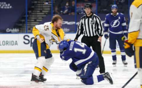 Mar 15, 2021; Tampa, Florida, USA; Nashville Predators right wing Mathieu Olivier (25) and Tampa Bay Lightning left wing Pat Maroon (14) fight during the third period at Amalie Arena. Mandatory Credit: Kim Klement-USA TODAY Sports