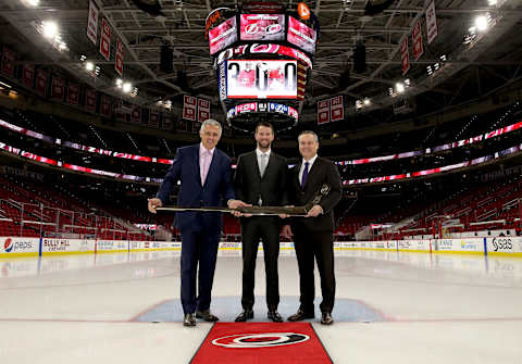 RALEIGH, NC – APRIL 7: Ron Francis, President of Hockey Operations for the Carolina Hurricanes and Assistant General Manager Brian Tatum present Hurricanes goaltender Cam Ward