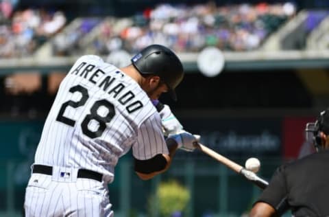 Aug 21, 2016; Denver, CO, USA; Colorado Rockies third baseman Nolan Arenado (28) hits a three run home run in the first inning against the Chicago Cubs at Coors Field. Mandatory Credit: Ron Chenoy-USA TODAY Sports