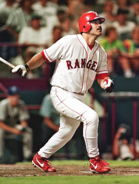 Rafael Palmeiro of the Texas Rangers watches his two-run homerun leave the Ballpark in Arlington 06 August 1999 in Arlington, Texas, in the the fourth inning against the Toronto Blue Jays. AFP PHOTO/PAUL BUCK (Photo by – / AFP) (Photo credit should read -/AFP/Getty Images)