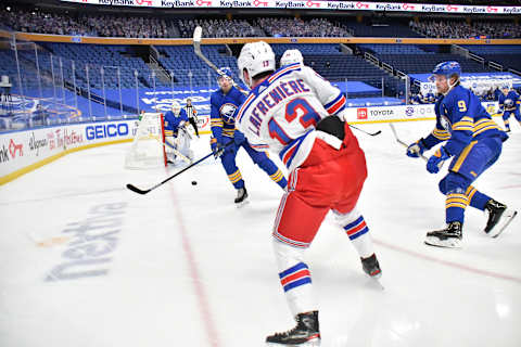 Jan 28, 2021; Buffalo, New York, USA; New York Rangers left wing Alexis Lafrenire (13) shoots on goal as Buffalo Sabres goaltender Linus Ullmark (35) and center Jack Eichel (9) defend in the first period at KeyBank Center. Mandatory Credit: Mark Konezny-USA TODAY Sports