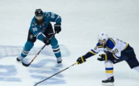 May 25, 2016; San Jose, CA, USA; St. Louis Blues left wing Alexander Steen (20) reaches for the puck against San Jose Sharks defenseman Brent Burns (88) during the second period in game six of the Western Conference Final of the 2016 Stanley Cup Playoffs at SAP Center at San Jose. Mandatory Credit: Kelley L Cox-USA TODAY Sports