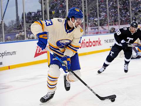 Mar 13, 2022; Hamilton, Ontario, CAN; Buffalo Sabres defenseman Mattias Samuelsson (23) carries the puck past Toronto Maple Leafs forward Michael Bunting (58) during the third period in the 2022 Heritage Classic ice hockey game at Tim Hortons Field. Mandatory Credit: John E. Sokolowski-USA TODAY Sports