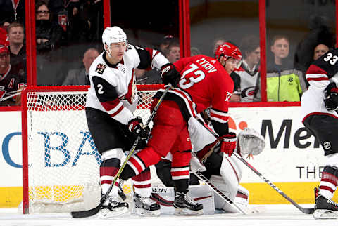 RALEIGH, NC – MARCH 22: Valentin Zykov #73 of the Carolina Hurricanes attempts to create traffic in the crease as Luke Schenn #2 of the Arizona Coyotes battles to defend during an NHL game on March 22, 2018 at PNC Arena in Raleigh, North Carolina. (Photo by Gregg Forwerck/NHLI via Getty Images)