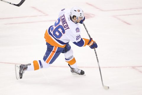 Mar 9, 2015; Toronto, Ontario, CAN; New York Islanders center Tyler Kennedy (26) shoots against the Toronto Maple Leafs at Air Canada Centre. The Islanders beat the Maple Leafs 4-3 in overtime. Mandatory Credit: Tom Szczerbowski-USA TODAY Sports