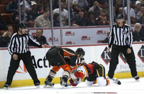 ANAHEIM, CA: Ryan Kesler #17 of the Anaheim Ducks brings down Kris Russell #4 of the Calgary Flames to end their fight on November 25, 2014. (Photo by Stephen Dunn/Getty Images)