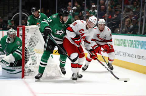 DALLAS, TEXAS – FEBRUARY 11: Ryan Dzingel #18 of the Carolina Hurricanes skates the puck against Mattias Janmark #13 of the Dallas Stars in the second period at American Airlines Center on February 11, 2020 in Dallas, Texas. (Photo by Ronald Martinez/Getty Images)