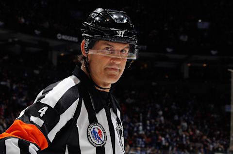 TORONTO, ONTARIO – NOVEMBER 12: Referee Wes McCauley #4 works the game between the Toronto Maple Leafs and the Calgary Flames at the Scotiabank Arena on November 12, 2021 in Toronto, Ontario, Canada. (Photo by Bruce Bennett/Getty Images)