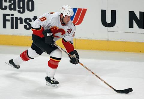 CHICAGO – NOVEMBER 12: Defender Robyn Regehr #28 of the Calgary Flames advances the puck against the Chicago Blackhawks during the game at the United Center on November 12, 2003 in Chicago, Illinois. The Flames won 6-2. (Photo by Jonathan Daniel/Getty Images)