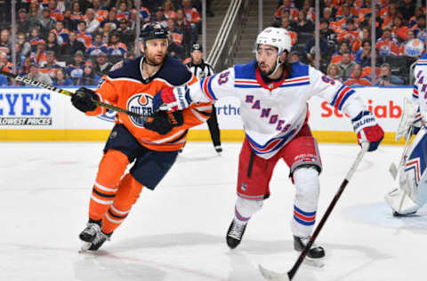 EDMONTON, AB – MARCH 11: Zack Kassian #44 of the Edmonton Oilers battles for the puck against Mika Zibanejad #93 of the New York Rangers on March 11, 2019 at Rogers Place in Edmonton, Alberta, Canada. (Photo by Andy Devlin/NHLI via Getty Images)