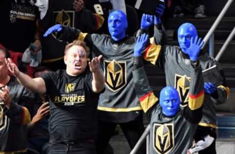 LAS VEGAS, NV – MAY 18: Vegas Golden Knights crowd igniter Cameron Hughes (L) and members of Blue Man Group get fans pumped up during Game Four of the Western Conference Finals between the Winnipeg Jets and the Golden Knights during the 2018 NHL Stanley Cup Playoffs at T-Mobile Arena on May 18, 2018 in Las Vegas, Nevada. The Golden Knights won 3-2. (Photo by Ethan Miller/Getty Images)