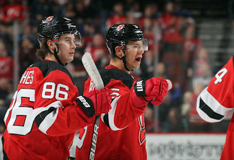 NEWARK, NEW JERSEY – MARCH 06: Connor Carrick #5 of the New Jersey Devils (R) celebrates his goal at 17:58 of the second period against the St. Louis Blues and is joined by Jack Hughes #86 (L) at the Prudential Center on March 06, 2020 in Newark, New Jersey. (Photo by Bruce Bennett/Getty Images)