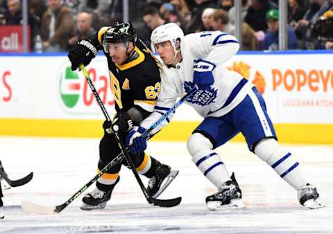 Nov 6, 2021; Toronto, Ontario, CAN; Toronto Maple Leafs forward Mitch Marner (16) battles for position with Boston Bruins forward Brad Marchand (63) in the first period at Scotiabank Arena. Mandatory Credit: Dan Hamilton-USA TODAY Sports