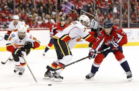 Nov 13, 2015; Washington, DC, USA; Washington Capitals right wing T.J. Oshie (77) battles for the puck with Calgary Flames defenseman T.J. Brodie (7) and Flames defenseman Mark Giordano (5) in the second period at Verizon Center. The Flames won 3-2 in overtime. Mandatory Credit: Geoff Burke-USA TODAY Sports