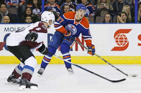 Feb 20, 2016; Edmonton, Alberta, CAN; Edmonton Oilers forward Connor McDavid (97) makes a pass in front of Colorado Avalanche defensemen Erik Johnson (6) during the first period at Rexall Place. Mandatory Credit: Perry Nelson-USA TODAY Sports