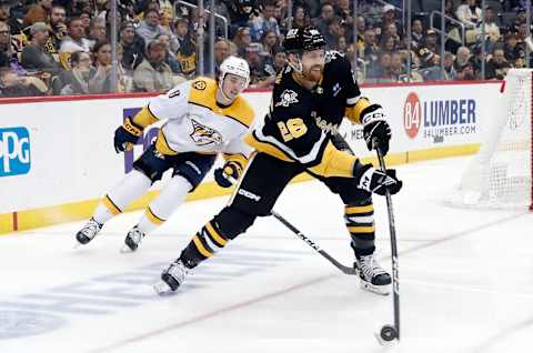 Mar 30, 2023; Pittsburgh, Pennsylvania, USA; Pittsburgh Penguins defenseman Jeff Petry (26) moves the puck ahead of Nashville Predators center Cody Glass (8) during the third period at PPG Paints Arena. The Penguins shutout the Predators 2-0. Mandatory Credit: Charles LeClaire-USA TODAY Sports