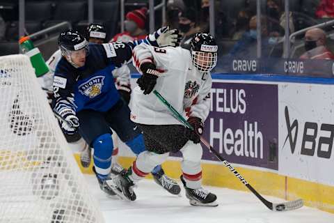 Marco Kasper #19 and captain of Austria evades Joel Määttä #32 of Finland during the 2022 IIHF World Junior Championship (Photo by Codie McLachlan/Getty Images)